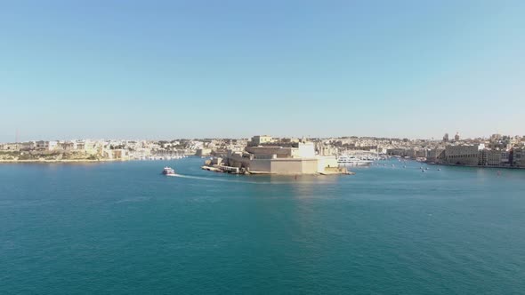 Aerial forward wide shot of Fort St. Angelo, Valletta, Malta.