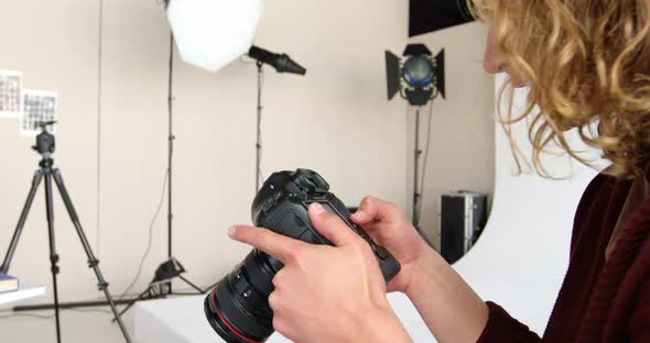 Photographer looking at photos on digital camera