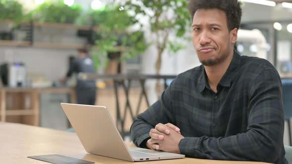 African American Man with Laptop Shaking Head As No Sign