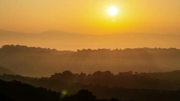 Sunrise time lapse over hills and mountains