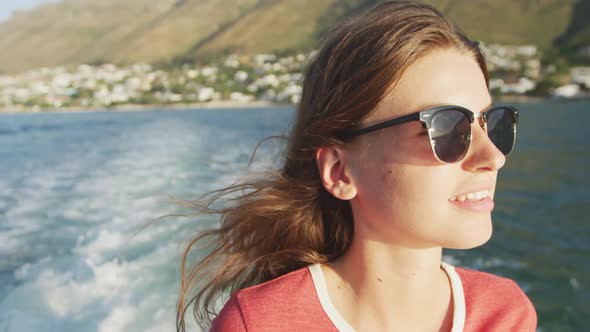 Side view of a teenage Caucasian girl enjoying her time on a boat