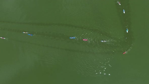 Aerial Top Down of Paddlers on Kayaks and SUP Boards Compete at Water Race