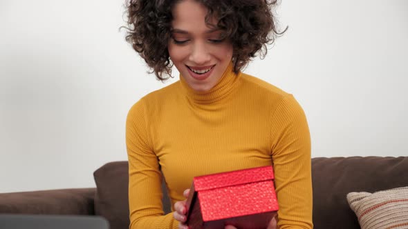 Close Up Happy Woman in Party Hat Opens Red Gift Box and Surprised Birthday