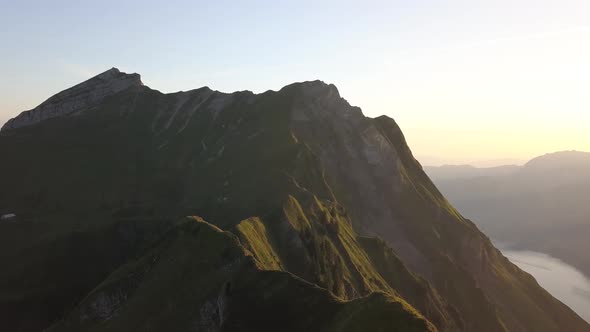 Aerial Rotation Shot Of A Mountain Ridge In Switzerland During Sunrise