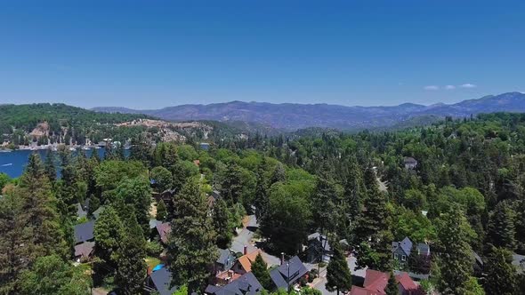 Drone camera moves towards the Arrowhead Lake and the houses in California, USA