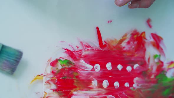 Artist painting an artwork using watercolors with hands