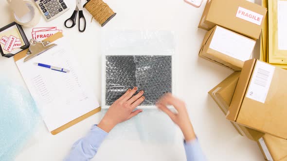 Woman Packing Frame To Bubble Wrap at Post Office 10