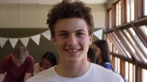 Portrait of teenage boy in school classroom