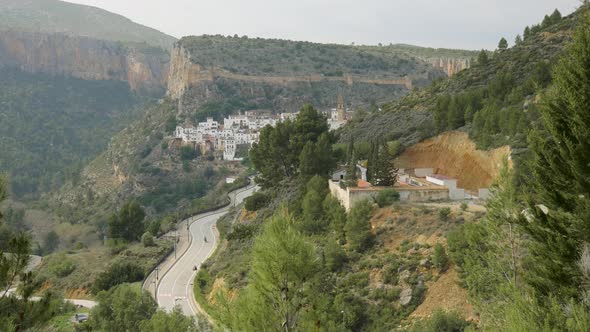 A motorbike rider drives up a windy mountain road to the old Spanish mountain village of Chulilla.