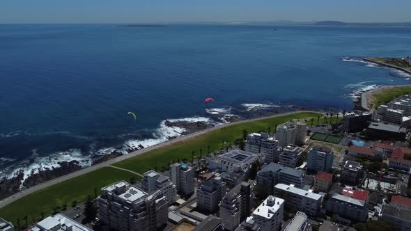 Drone shot of Sea Point, Cape Town - drone is flying over the boulevard, watching the ocean and some