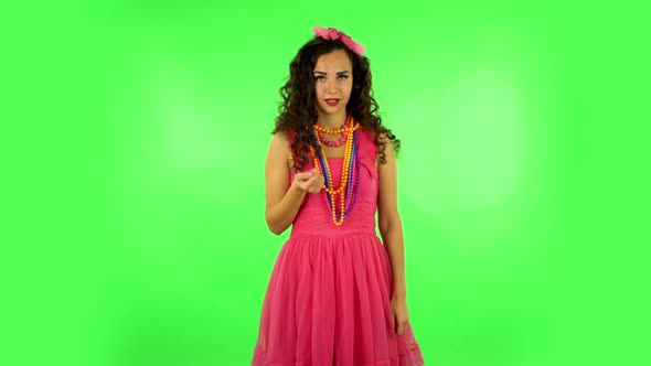 Curly Girl Flirts and Waving Hand, Showing Gesture Come Here. Green Screen at Studio