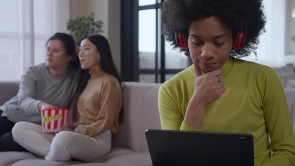 Thoughtful Absorbed Beautiful African American Woman Surfing Internet on Tablet Analyzing Emarket in