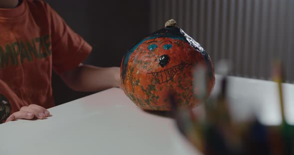 One Boy Decorating and Painting Pumpkin for Halloween