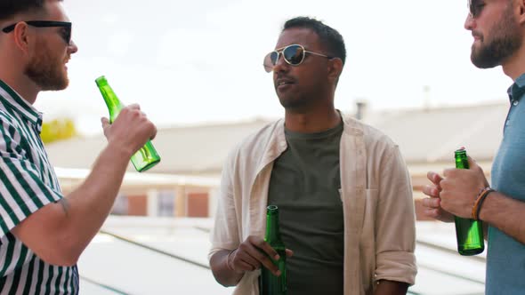 Happy Male Friends Drinking Beer at Rooftop Party