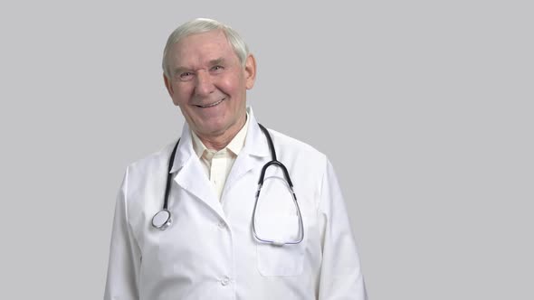 Portrait of an Old Attractive Laughing Doctor with Stethoscope.