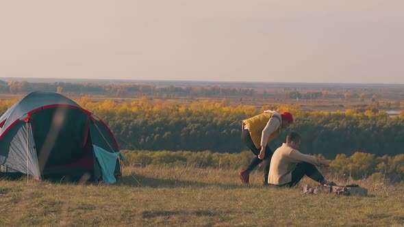 Guy Sits Near Boyfriend at Campfire and Supports Sad Man