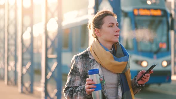 Portrait of a Young Caucasian Businesswoman in a Coat Walking Around the City on a Frosty Morning