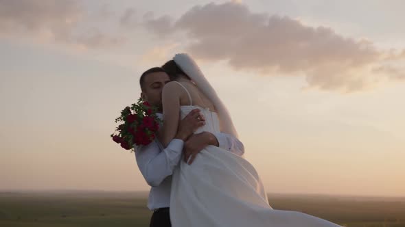 Close Up View Spinning Bride and Groom Red Roses