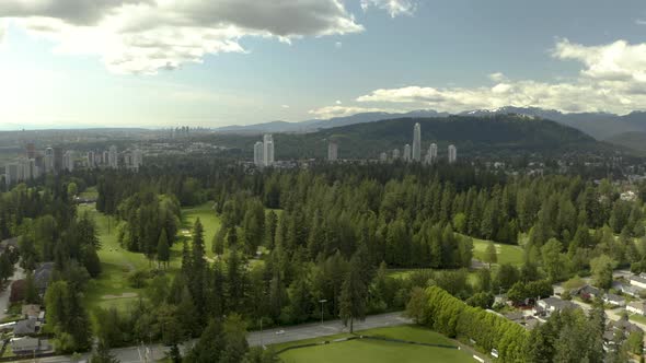 Aerial shot of golf course and Tri-Cities on background in Vancouver, British Columbia, Canada, Coqu