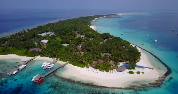 Luxury overhead island view of a white sandy paradise beach and aqua blue ocean background