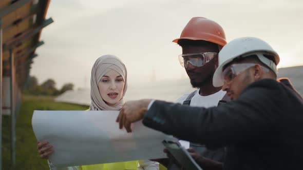 African American Technician Talking with Muslim Woman and Indian Man During