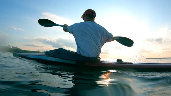 A Man Is Canoeing Across the Lake in Slow Motion