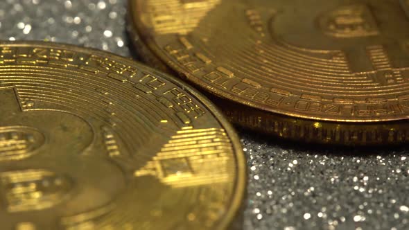 Bitcoin Coins are Illuminated in Closeup with an Alarming Flashing Red and Blue Light