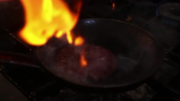 Flipping Burger Patty in Flames 