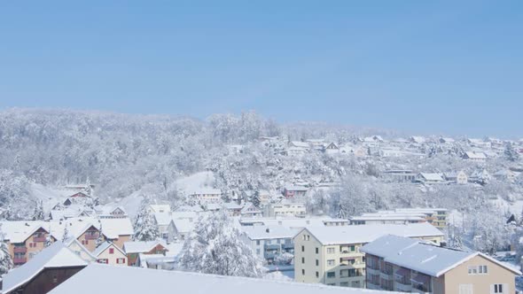 Winter in the Swiss Town on the Slopes of the Mountain.