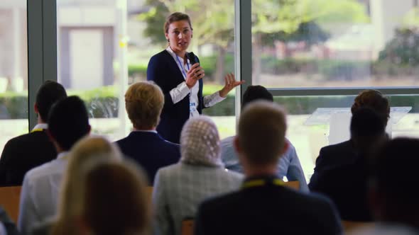 Female speaker speaks in a business seminar at modern office 4k