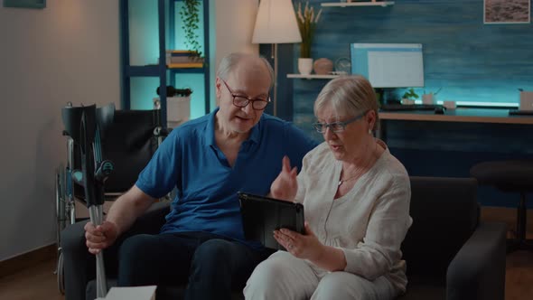 Married People Browsing Internet on Digital Tablet