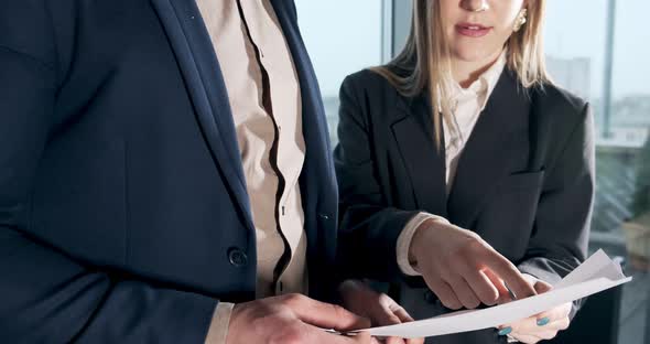 Man and a Woman Discussing Work in the Brightly Lit Modern Office. Concerned Male and Female Working