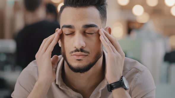 Closeup Young Unhealthy Sad Guy Massaging Temples Suffering From Headache Unhappy Depressed Arab Man