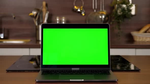 Green Screen Laptop Standing on Kitchen Table Computer with Chroma Key Display