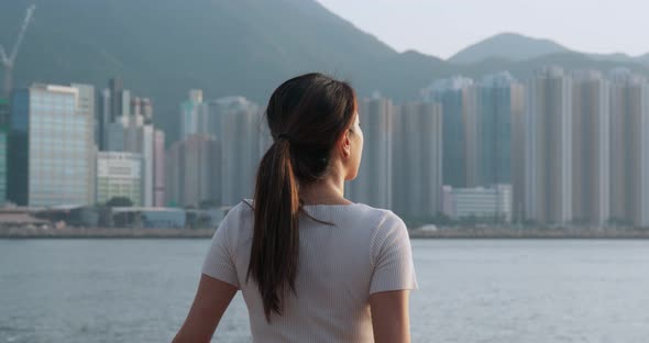 Woman Look Around in The City and Standing at The Seaside