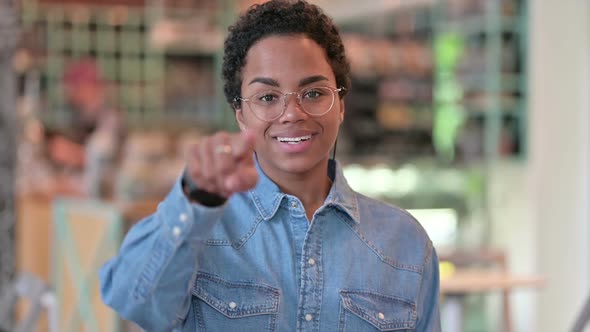 Portrait of African Woman with Pointing Finger and Inviting