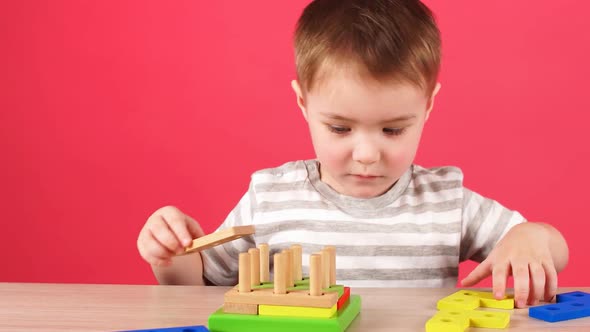 Little Boy Plays in Developing Game, Education and Daycare Concept