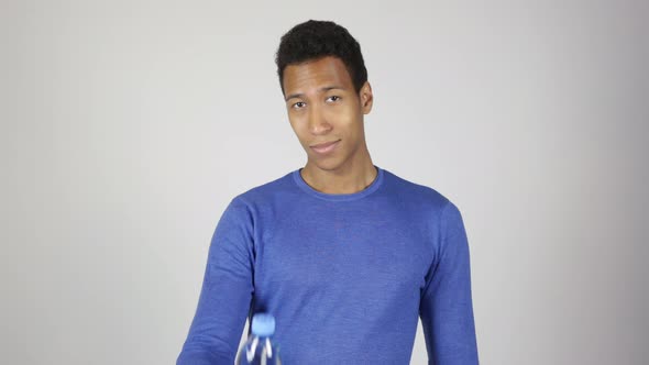 African Man Offering Water Bottle White Background