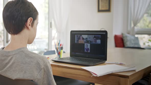 Young boy attending an online lesson during the COVID-19 lockdown