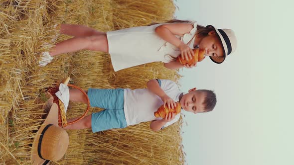 Vertical Screen Children Eating Croissants By Wheat Field