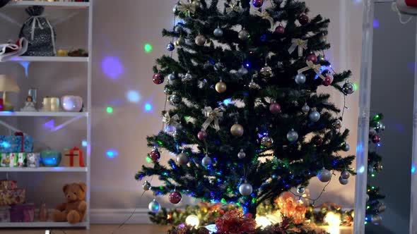 Decorated Christmas Tree in Living Room with Lights Shining Indoors