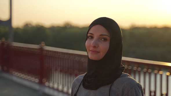 Portrait of Muslim Female in Hijab Posing Outdoors