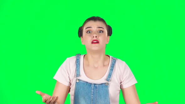 Girl Looking at Camera with Anticipation, Then Very Upset Against Green Screen. Slow Motion