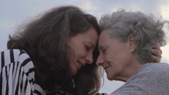 Beautiful Women with Closed Eyes Touching Foreheads