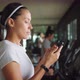 Attractive Young Mixed Race Girl Using Fitness App on Mobile Phone in the Gym. Health Sport - VideoHive Item for Sale