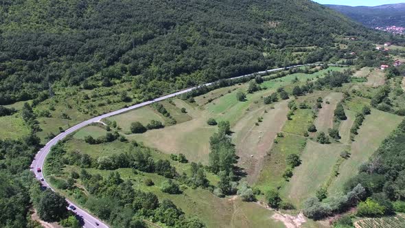 Aerial view of highway through green forested hills, Croatia