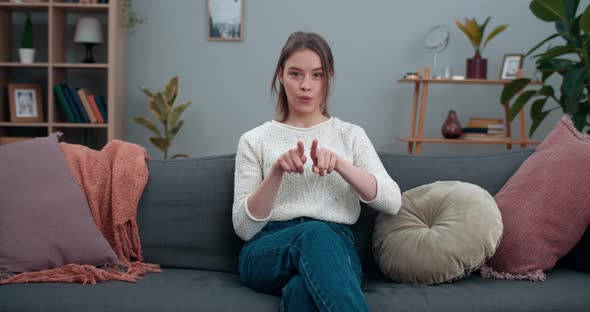 Young Serious Woman Showing with Deafmute Sign Language Me Too and Looking To Camera