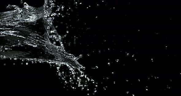 Water spurting out against Black Background, Slow motion 4K