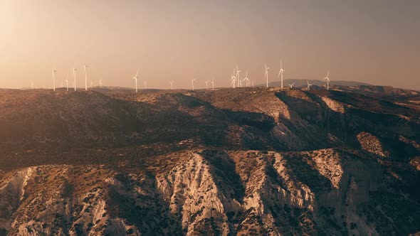 Sunlight Over Wind Turbines Blades Rotate Generate Energy Electricity on Field in Cyprus