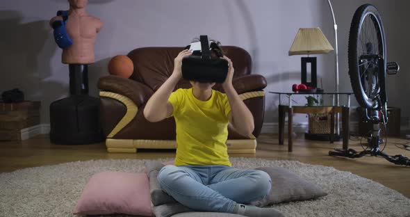 Cheerful Caucasian Boy in Yellow T-shirt Taking on VR Glasses. Cute Smiling Child Trying New Device